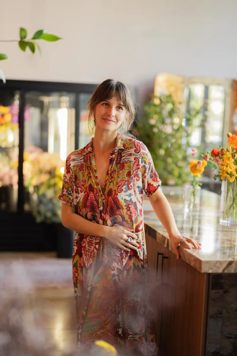 Smiling florist in warmly lit flower shop