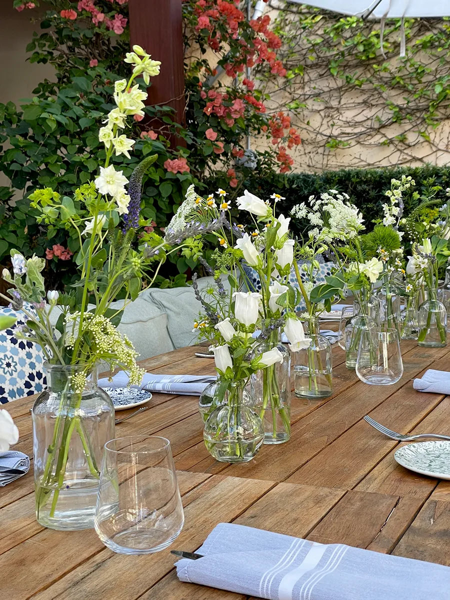 Outdoor dining with delicate white floral decor