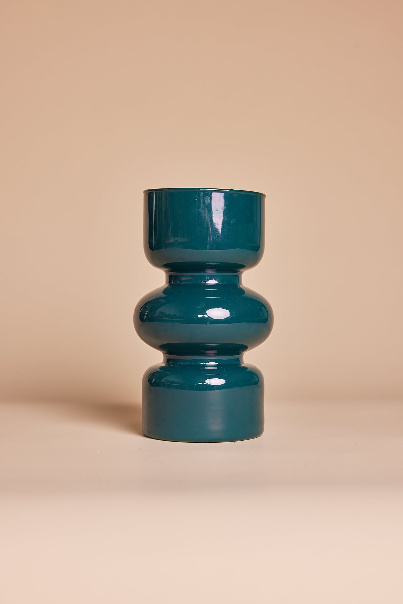 Glossy teal vase with sleek sculptural design