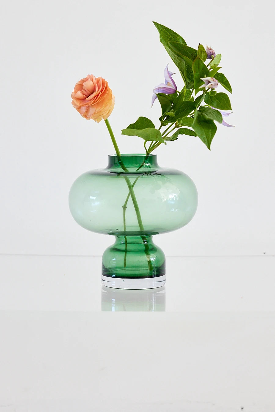 Green glass vase with delicate floral display