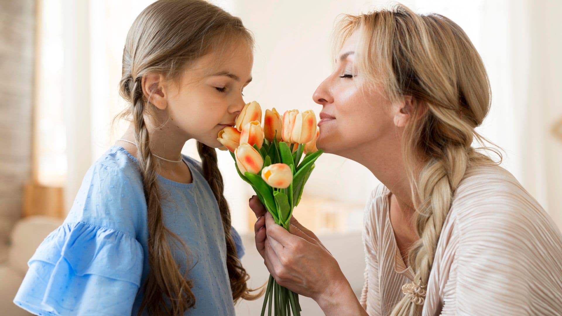 daughter gifting flowers to mom